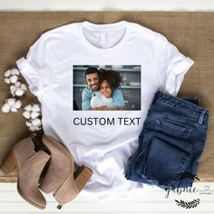 Collaborate with our designers to create your unique and personalized t-shirt. We have over 100s of fonts, graphics, and colors to choose from. You can even send in your own photos! This is a collaborative experience, you will receive mockups along with way for approval. We ask that you have a basic idea of what you want in mind (i.e.- kind of graphics, words, position of text and/or graphics, etc.) but we are willing to collaborate with you along the way to make sure you receive the perfect cus Customizable Short Sleeve T-shirt With Sublimation Design, Custom Print Cotton T-shirt For Customization, Custom Print Relaxed Fit Graphic Tee, Relaxed Fit Custom Print Graphic Tee, Cotton T-shirt With Custom Print, Casual Sublimation Design T-shirt With Custom White Print, Custom Graphic Print Sublimation Short Sleeve Shirt, Customizable Cotton Graphic Print T-shirt, Custom Print Short Sleeve T-shirt