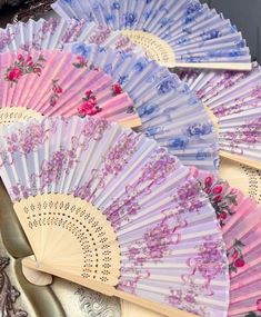 several different colored fan sitting on top of a table