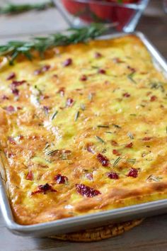 a casserole dish with cheese and herbs on top