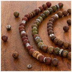 Upgrade your jewelry with these Wood & Stone Bead Strands. These strands feature wooden beads with a busy wood grain finish and stone beads in smooth greens, pinks, and reds. They are separated by stylish metal spacers. Work these beads into a bracelet or wrap them around a stylish necklace! Add new dimensions and depth to your next project with beads for every look. Details: 	 Strand Length: 7" 	 Smallest Bead Dimensions: 1.7mm x 5.7mm 	 Largest Bead Dimensions: 8.2mm x 8.2mm 	 Approximate Hole Wooden Beaded Bracelets With Round Beads, Earthy Spacer Beads For Jewelry Making, Brown Beaded Bracelets For Jewelry Making, Brown Gemstone Beads Bracelets For Jewelry Making, Brown Gemstone Beads For Jewelry Making, Spiritual Wood Round Beads Jewelry, Wooden Beaded Necklaces With Round Beads, Wooden Beaded Jewelry With Round Beads, Bohemian Wood Beaded Bracelets