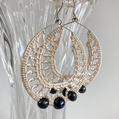 Adorable shimmering white crochet earrings, made of satin viscose silk thread. These beaded hoop earrings have thee black pearls dangling beautifully around your neck. Unique piece of jewelry that will make you shine. These elegant cocktail party earrings are ideal accessory for special occasions like evening parties, weddings, cocktails and other special events. Perfect gift for your wife or girlfriend for Valentine's day or birthdays.   Size Approx 3" / 7.5 cm long 2 " / 5 cm wide Color white Bohemian White Crochet Earrings, Elegant Crochet Dangle Earrings, Elegant Dangle Macrame Earrings, Elegant Macrame Dangle Earrings, Elegant Cocktail Party, Silk Crochet, Large Drop Earrings, Elegant Crochet, Black Pearls