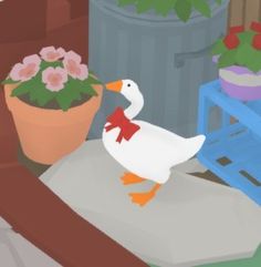 a white duck standing on top of a table next to a potted plant with pink flowers