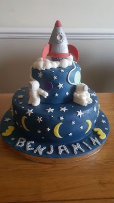 a cake that is sitting on top of a table with the moon and stars on it