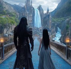 two people standing on a bridge looking at a waterfall and castle in the distance,