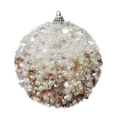 a white beaded ornament hanging from a chain on a white background with lots of beads