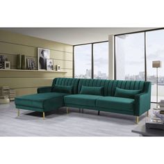 a living room scene with focus on the green couch and large window overlooking the city