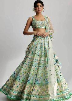 The avantika lehenga set is a stunning ensemble that exudes elegance and grace. Crafted with exquisite attention to detail, this ensemble showcases a beautiful fabric with intricate mirror work and delicate pompoms and tassels. The fabric used in this set is a luxurious blend of high-quality materials, carefully selected to enhance its visual appeal and durability. Winter Lengha, Green Indian Outfit, Bustier Blouse, Palazzos Pants, Gopi Vaid, Tailored Fashion, Indian Outfits Lehenga, Georgette Lehenga, Wedding Lehenga Designs