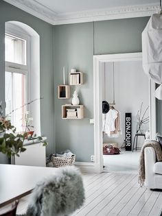 a living room filled with furniture and lots of white stuff on the wall next to a window