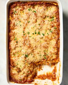 lasagna casserole with meat and cheese in a white dish on a table