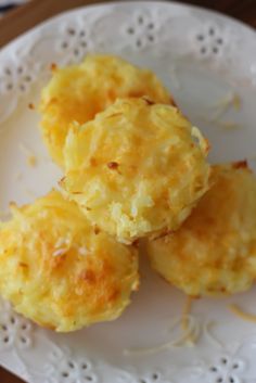 three biscuits on a white plate sitting on a table