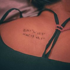 the back of a woman's shoulder with writing on it