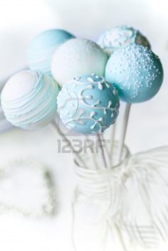 blue and white cake pops in a glass vase