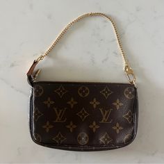 This Is An Authentic Louis Vuitton Pochette In Classic Monogram Canvas. The Compact Size Makes It Perfect For Everyday Use, While The Gold Metal Strap And Hardware Add A Touch Of Elegance. The Zip Closure Ensures Your Items Stay Secure While The Interior Brown Lining Complements The Brown Exterior Color. The Pochette Is Perfect For Any Occasion And Adds A Touch Of Luxury To Any Outfit. In Excellent Condition! Authentic Classic Monogram, Zipper Purse, Louis Vuitton Pochette, Metal Straps, Purse Bag, Monogram Canvas, Authentic Louis Vuitton, Louis Vuitton Bag, Mini Bag