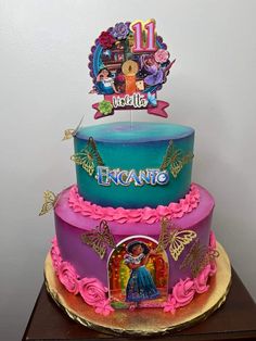 a three tiered cake decorated with an image of princess and the frog on top