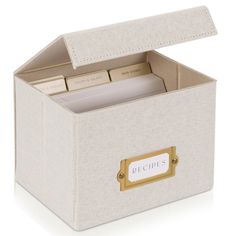 a white linen box with gold handles and labels on the lid that says recipe inside