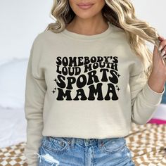 Get ready to proudly show off your sports mama status with this super soft and cozy Somebody's Loud Mouth Sports Mama sweatshirt! With its vibrant design and comfortable fit, you'll be the loudest and proudest mama in the stands. Cheer on your team in style and comfort with this must-have sweatshirt mama. Unisex fit Stay with your true size for a relaxed fit Size up for a trendy oversized fit This is a regular length sweatshirt, the model has it tucked. Current processing time is 5-10 business d Sporty Super Soft Fleece Sweatshirt, Letter Print Sweatshirt For Sports Season Workout, Workout Sweatshirt With Letter Print For Sports Season, Comfortable Graphic Print Sweatshirt For Sports, Comfortable Graphic Print Sports Sweatshirt, Sporty Fleece Activewear With Letter Print, Fall Gym Sweatshirt With Graphic Print, Trendy Letter Print Sweatshirt For Sports Season, Graphic Print Sweatshirt For Gym Use In Fall