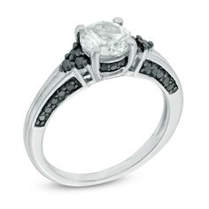 an engagement ring with black and white diamonds