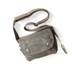 The Men's Canvas Shoulder Bag is a stylish choice for men who are looking for a practical and masculine bag. Made of sturdy canvas with a vintage look, this bag is built to last! A Small Waxed Canvas Crossbody Bag ideal for your travels The men's canvas shoulder bag has a very masculine look with its sleek and stylish design. The flap with snap adds a touch of sophistication to your outfit. The choice of canvas as the material of manufacture adds a vintage touch that will appeal to retro style l Functional Waxed Finish Shoulder Bag For Outdoor Activities, Functional Shoulder Bag For Outdoor Activities With Waxed Finish, Classic Waxed Canvas Shoulder Bag For Outdoor, Vintage Canvas Bag With Adjustable Strap For Outdoor, Vintage Canvas Travel Bag With Waxed Finish, Rugged Shoulder Bag With Canvas Lining For Travel, Rectangular Canvas Shoulder Bag For Adventure, Vintage Travel Canvas Bag With Waxed Finish, Canvas Rectangular Shoulder Bag For Adventure