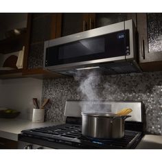 a pot on the stove with steam coming from it