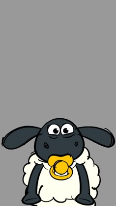 a black and white sheep with a yellow bell