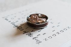 two wedding rings sitting on top of an open book