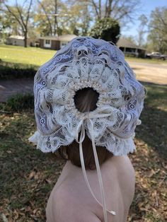 This delicate bonnet is made completely of lace strips sewn together. Ribbons tie at back and under chin. Perfect for any occasion! Measure from bottom of earlobe over the top of head to bottom of earlobe Note: 2 different bonnets are depicted. Laces may vary due to availability Adjustable Lace Wedding Bonnet, Wedding Bonnet With Lace Trim, Adjustable Ruffled Bonnet, Fitted Cotton Bonnet With Lace Trim, Fitted Cream Bonnet With Lace Trim, White Adjustable Lace Bonnet, White Lace Adjustable Bonnet, Vintage White Adjustable Bonnet, Lace Baby Bonnet