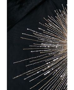 the back side of a black dress with gold sequins