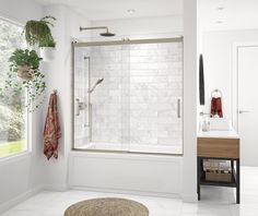 a bathroom with a shower, sink and mirror