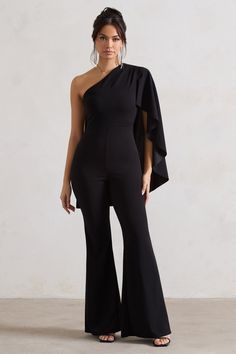 A jumpsuit worthy of its name, Pristine is the perfect occasion outfit. Designed in a figure hugging scuba crepe, this black jumpsuit has an artful asymmetric neckline and single shoulder cape sleeve draped elegantly across the back. Finish off this flared-leg look with strappy stilettos and some statement earrings.Features - Premium scuba crepe - Asymmetric neckline - Cape sleeve- Invisible zip closure - Flared legSizing & Fit Model is 5'8 and wears UK size 8 / US size 4Product Information Designed exclusively by Club L London Unlined with good stretch Premium scuba crepe in Black (95% Polyester, 5% Elastane) 84cm total leg length SKU: CL132331002 Jumpsuit With Cape, One Shoulder Cape, Shoulder Cape, Occasion Outfit, Black Dress Prom, Strappy Stilettos, Asymmetric Neckline, Party Dress Long Sleeve, Cape Sleeves