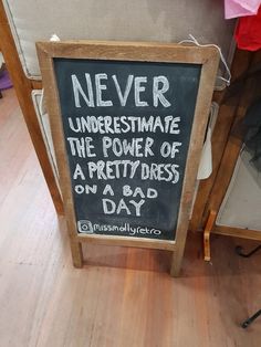 a sign that says never underestivate the power of a pretty dress on a bad day