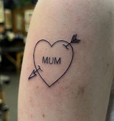 a heart with an arrow and the word mum on it is shown in black ink