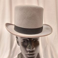 Broadway Quality, Made In Usa, 100% Wool Top Hat. Crown: 5-Inch High / Brim: 2-Inch Wide. This Is The Perfect Moderately Priced Top Hat Without The Cheap Look. This Hat Is Often Worn For Formal Wear Events. Color: Black, Brown, Gray American / Nearest 1/8 Inch / Metric Cm / Size Code 6 3/4 21 1/8 54 Small 6 7/8 21 1/2 55 Small / Child L 7 1/2 23 1/2 60 X-Large 7 5/8 23 7/8 61 X-Large These Hats Are Of High Quality And No Longer Manufactured So The Sizes And Quantity Available Are Finite. We Classic Gray Hat Bands With Flat Brim, Classic Gray Flat Brim Hat Band, Classic Gray Flat Brim Hat, Classic Gray Brimmed Hat, Classic Gray Hat With Short Brim, Adjustable Gray Brimmed Felt Hat, Adjustable Brimmed Gray Felt Hat, Gray Curved Brim Hat For Kentucky Derby, Gray Brimmed Hat For Kentucky Derby