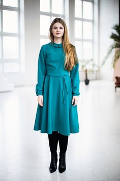 Teal Dress, Long Sleeve Dress, Flared Dress Green dress with collar ➤ Features > dress length: 105cm / 41,33'' > circle skirt > long sleeves > collar > knee length > lining > zipper on the side ➤ Sizing My Size Guide in FAQ section below will help you define the perfect size match. The item can also be made according to your measurements - just message them to me. ➤ Delivery Your item is made-to-order and will be ready within 2-7 days. Average delivery times: > North Amer Fall Workwear Dress With High Neck, Fitted Knee-length Vintage Dress For Winter, Fitted Vintage Winter Dress, Fitted A-line Belted Dress For Fall, Solid High Neck Dress For Winter, High Neck Green Dress For Fall, Fall Season High Neck Green Dress, Green Winter Workwear Dress, Green High Neck Dress For Fall