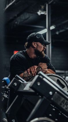 a man sitting on top of a motorcycle in a garage