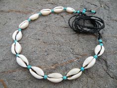 Cowrie shell & Turquoise necklace choker Macrame Beach Boho Hippie Jewelry This boho necklace is created using the macramé technique. It is made by a high quality black waxed thread and 13 pcs of natural cowrie sea shells. Also we use a Turquoise beads to complete design. Waxed thread gives the product durability and strength, and elegant natural appearance. It's a beautiful gift and a nice accessory what you can wear every day. Necklace characteristics: *This necklace is adjustable, with a Beachy Shell Necklace Strand For Festivals, Beachy Shell Strand Necklace For Festival, Beachy Strand Shell Necklace For Festival, Adjustable Bohemian Choker For Vacation, Bohemian Turquoise Necklace For Beach Season, Ocean-inspired Strand Necklace For Festivals, Adjustable Beachy Necklace For Festivals, Bohemian Strand Choker For Vacation, Turquoise Shell Strand Necklace For Vacation