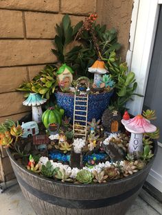 a potted planter filled with lots of plants and miniature gnome figurines