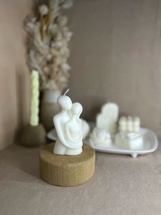 a small white figurine sitting on top of a table