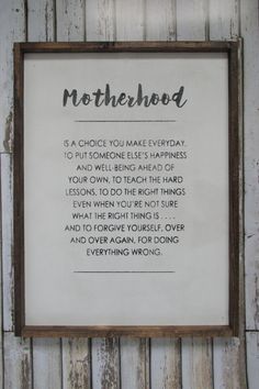 a framed sign that says motherhood is a choice you make everyday to put someone else's happiness and well - being ahead