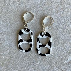 two pairs of black and white animal print earrings