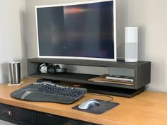 a computer monitor and keyboard on a desk