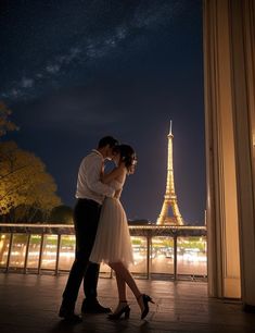 a couple kissing in front of the eiffel tower