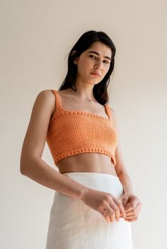 "The Square Neck Crop Top -- our iconic hand-knit cropped top is a year-round wardrobe staple. Thoughtfully designed to elevate your outfits, this versatile piece serves as the perfect blend of elegance and versatility. Handcrafted with utmost care, the Square Neck Crop Top is made from the finest blend of Oeko-Tex cotton, ensuring a luxuriously soft feel against your skin. With its square neckline, wide shoulder straps, and comfortable fit, this top flatters all silhouettes while elegantly framing your décolletage, accentuating your natural beauty with ease. Inspired by the desire for effortless style throughout the year, it can be paired with your favorite linen pants or a gathered long skirt and seamlessly take you from morning strolls to seaside dinners. Every top is made to order. To Seamless Cropped Knit Crop Top, Cropped Knit Top For Beach, Fitted Cropped Knit Top For Beach, Fitted Knitted Orange Top, Fitted Orange Knitted Tops, Seamless Fitted Cropped Crochet Top, Fitted Seamless Cropped Crochet Top, Summer Cropped Knitted Tops, Summer Knitted Cropped Tops