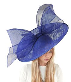 Hats By Cressida Kentucky Derby Ascot Fascinator Hats Royal Blue Chantal Statement Fascinator Hat Gorgeous extra large royal blue sinamay flat saucer hatinator is trimmed with a royal blue modern take on a bow This blue fascinator measures 48cm wide or about 19 inches The headpiece is mounted with a matching headband If you prefer a headband to match your hair, please make a note at check out what colour headband you want. The Chantal Fascinator Hat is the perfect accessory to complete your elegant formal look. Made with an extra large sinamay saucer base, this statement hatinator features a big sinamay bow and a modern design that's perfect for any occasion. Whether you're attending a wedding, a derby race, or Royal Ascot, this headpiece is sure to make you stand out. You can even wear it Blue Summer Fascinator Hat, Blue Fascinator With Short Brim For Summer, Blue Short Brim Fascinator For Summer, Summer Blue Fascinator With Short Brim, Blue Short-brimmed Fascinator For Summer, Blue Short Brim Headpiece For Summer, Blue Headpieces For Church In Spring, Blue Top Hat For Summer Parties, Blue Top Hat For Spring Party