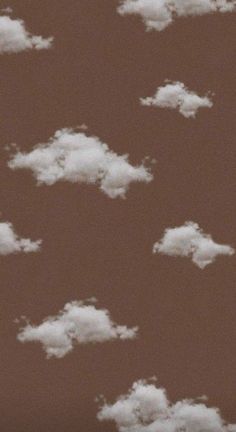 the sky is filled with white clouds in brown and tan tones, as well as some smaller ones