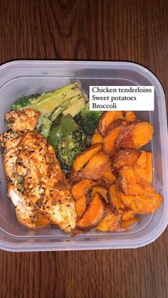 a plastic container filled with chicken, broccoli and sweet potato wedges on top of a wooden table