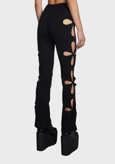 Edgy Black Bottoms With Holes, Edgy Straight Leg Bottoms With Holes, Edgy Elastane Pants For Night Out, Edgy Stretch Flare Pants, Black Stretch Bottoms With Holes, Edgy Stretch Elastane Pants, Fitted Black Cutout Bottoms, Fitted Black Bottoms With Cutout, Fitted Black Bottoms With Cutout Details