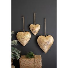 three heart shaped ornaments hanging on the wall