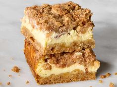 two pieces of cake sitting on top of a white counter next to another piece of cake