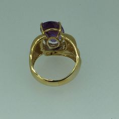 "This fashionable large 14kt Yellow Gold Oval Amethyst Ring consisting of 1- 14mm x 10mm, 5.76ct total weight fine genuine oval Amethyst is 4 prong set in a heavy mounting with design work on both sides in highly bright polished. The overall width is 16mm or 5/8\". The finger size is 8 1/2 and can be resized for an additional $95.00 upon request. This item would Retail for $890.00" Modern Amethyst Ring With Center Stone For Formal Occasions, Oval Amethyst Ring With Accent Stones In Yellow Gold, Oval Gold Amethyst Ring With Center Stone, Oval Amethyst Ring With Center Stone In Gold, Oval Yellow Gold Amethyst Ring With Accent Stones, Gold Solitaire Amethyst Ring For Formal Occasions, Luxury Oval Amethyst Ring With Center Stone, Gold Oval Amethyst Ring With Accent Stones, Modern Yellow Gold Amethyst Ring With Accent Stones