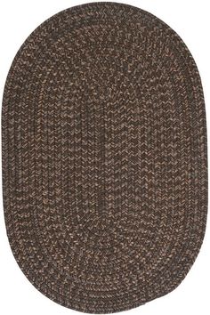 an oval rug with brown and tan colors on the bottom, it is made out of woven